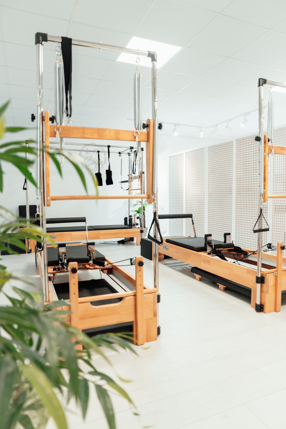 Pilates reformers in a bright, modern studio.